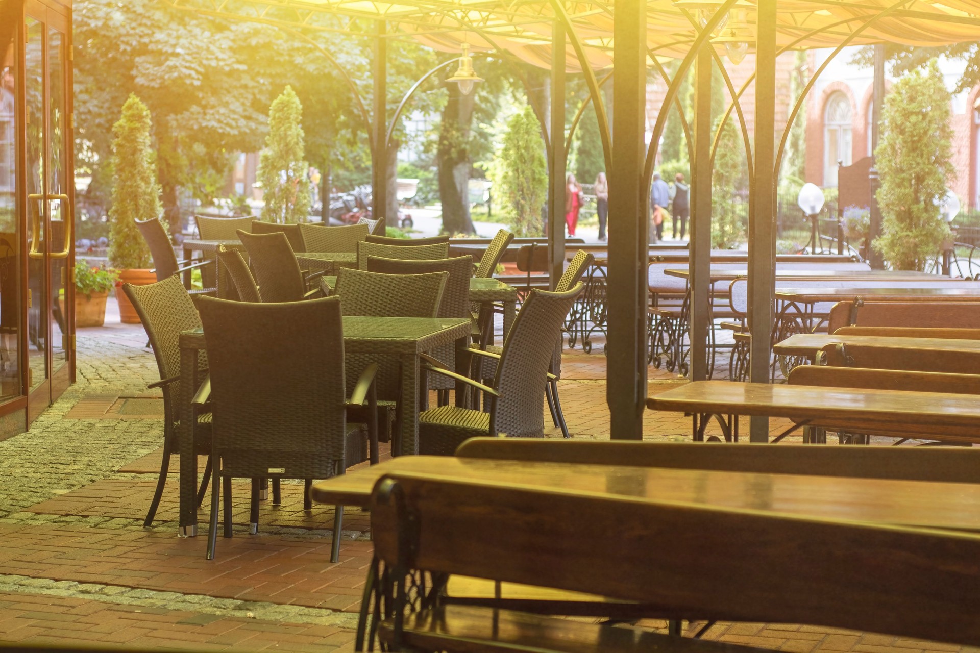 Empty tables at a street cafe during the summer heat.